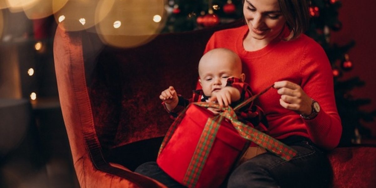 mother-with-her-baby-boy-celebrating-christmas_1303-25592